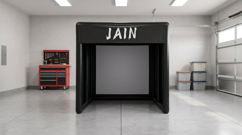 A black funjain inflatable golf simulator tent setup inside a spacious modern residential garage 