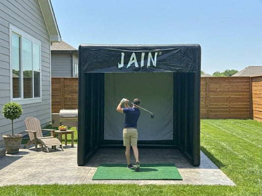 A professional FUNJAIN inflatable golf simulator fence was installed on the patio of a suburban home.