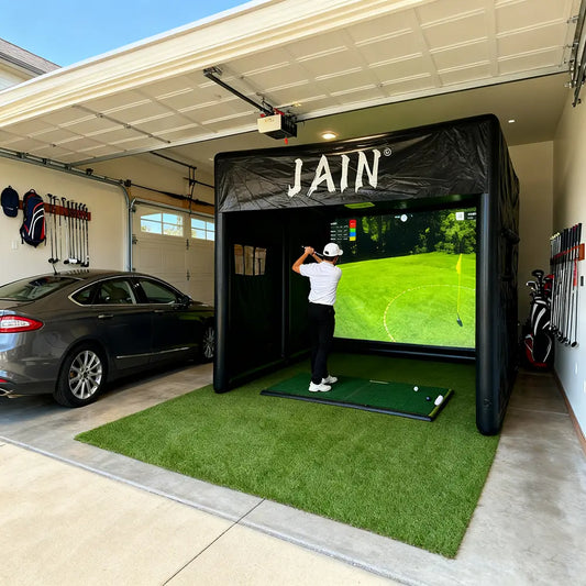 PVC inflatable golf simulator tent and indoor swing system for use in a garage.