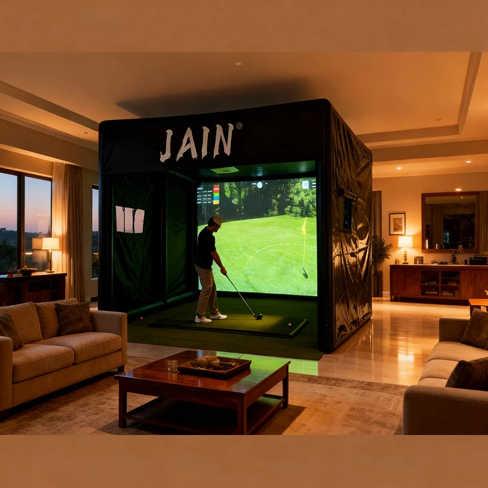 Man practicing swing inside a black inflatable golf simulator enclosure set up in a spacious living room.