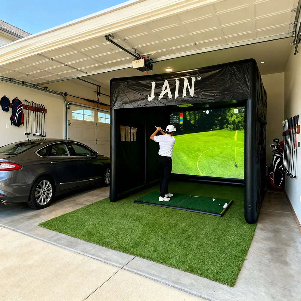 PVC inflatable golf simulator tent and indoor swing system for use in a garage.